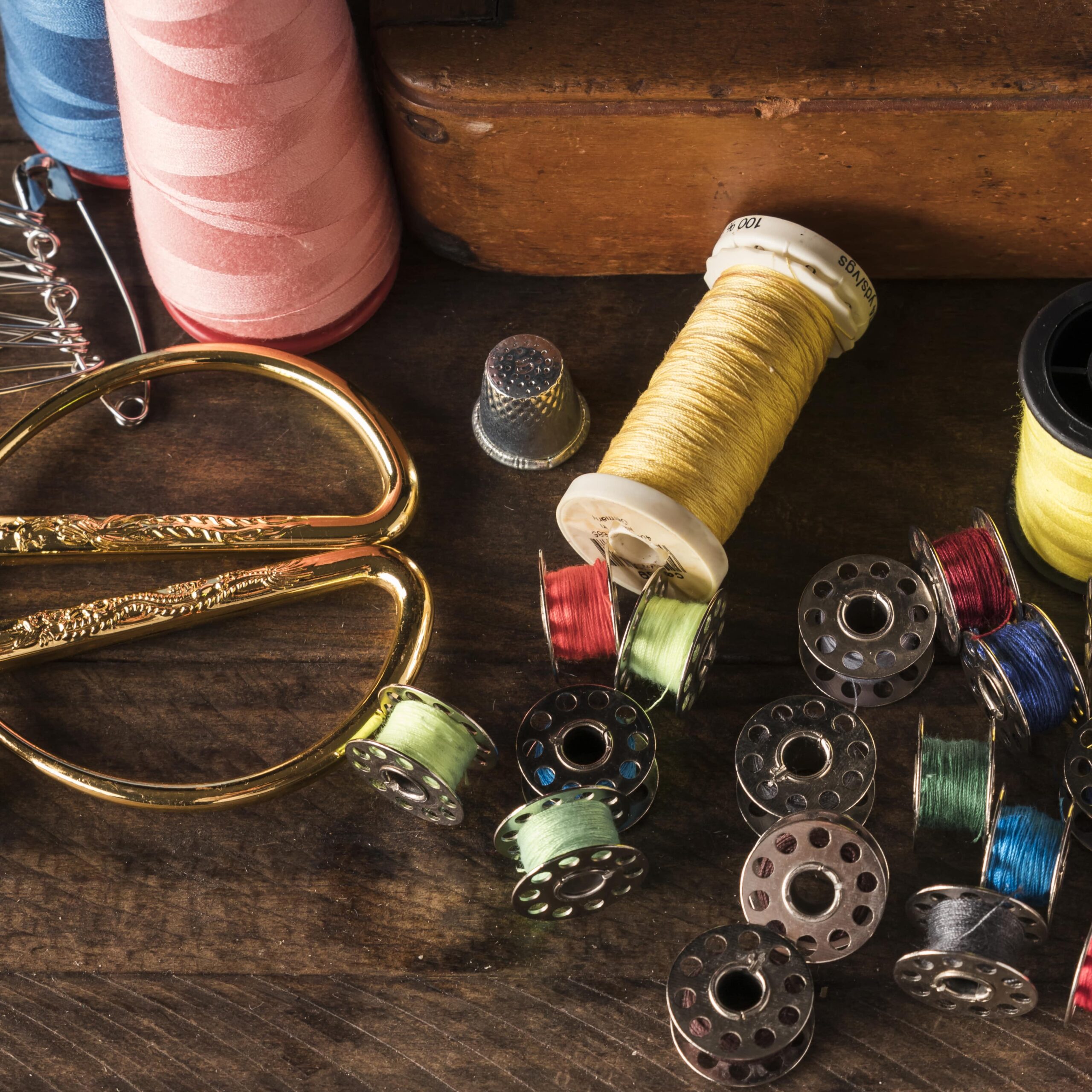 scissors-lying-near-threads-table-min